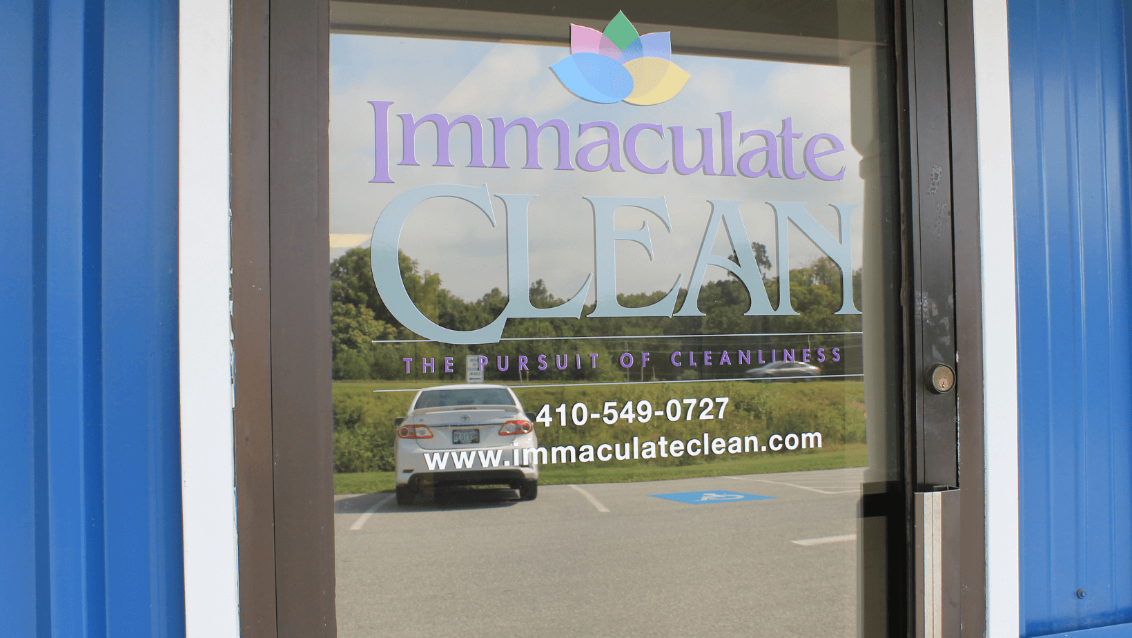purple-blue-and-yellow-logo-on-door-to-storefront