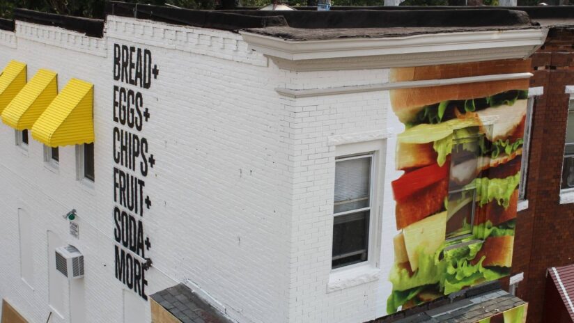 off-white-building-with-mural-of-sandwich-and-black-lettering