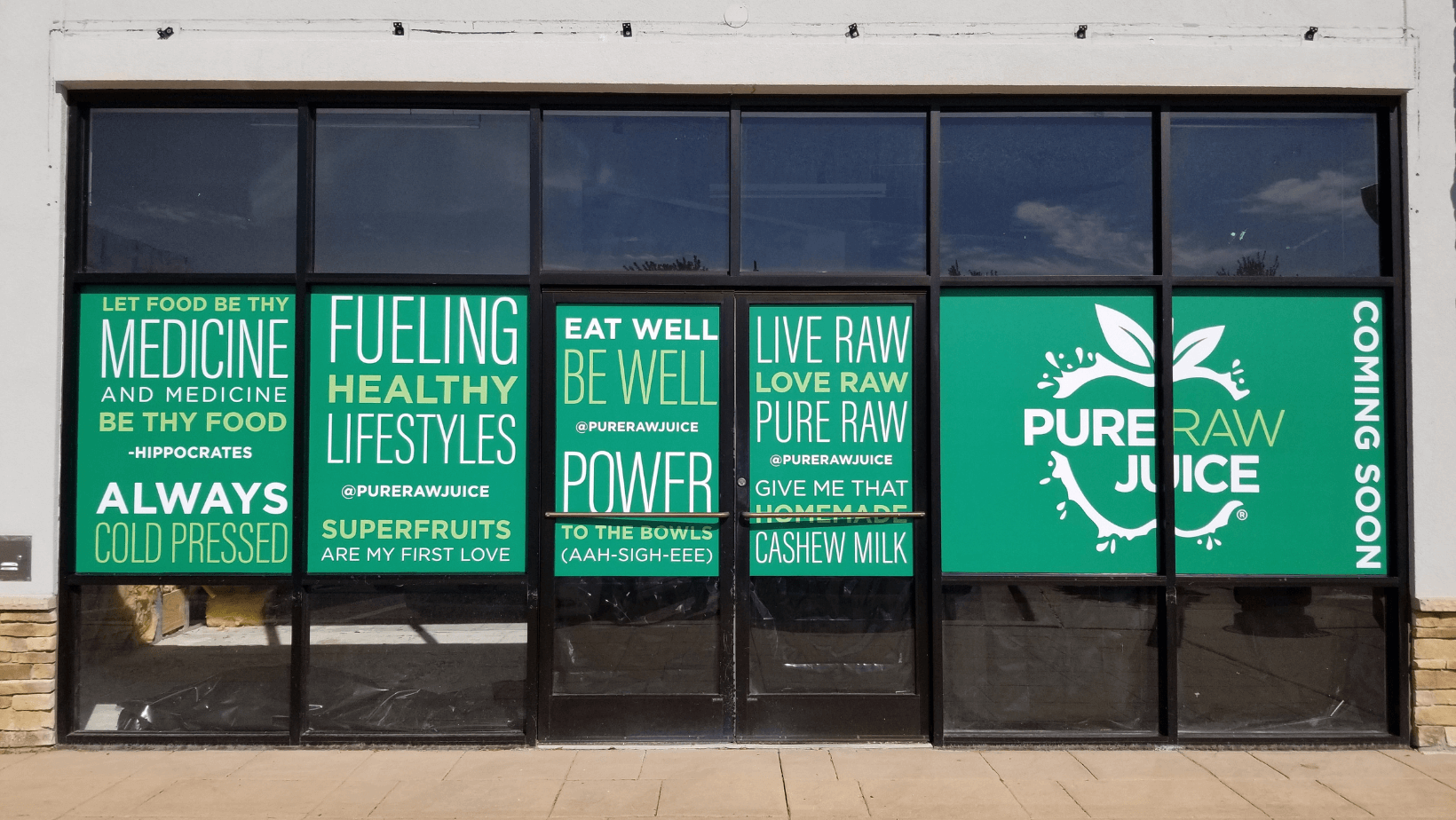 green-storefront-graphic-with-white-letters-and-logo